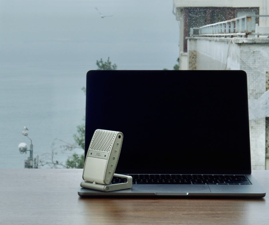 A Macbook Pro with a Tula Mic with a view of the sea in Istanbul